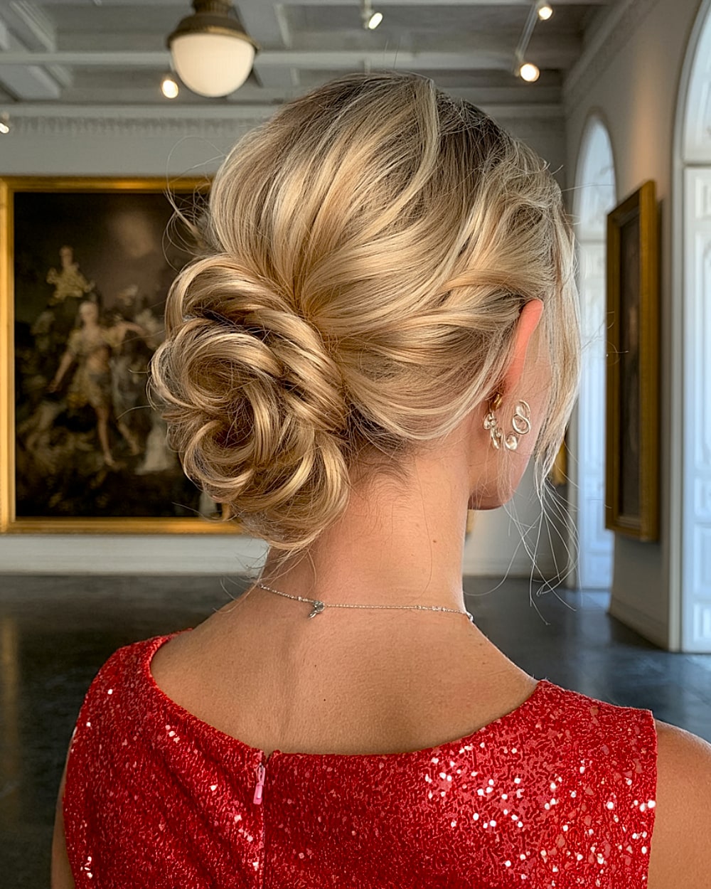 Voluminous blonde twirled bun updo for medium hair, an elegant and easy updo for special occasions