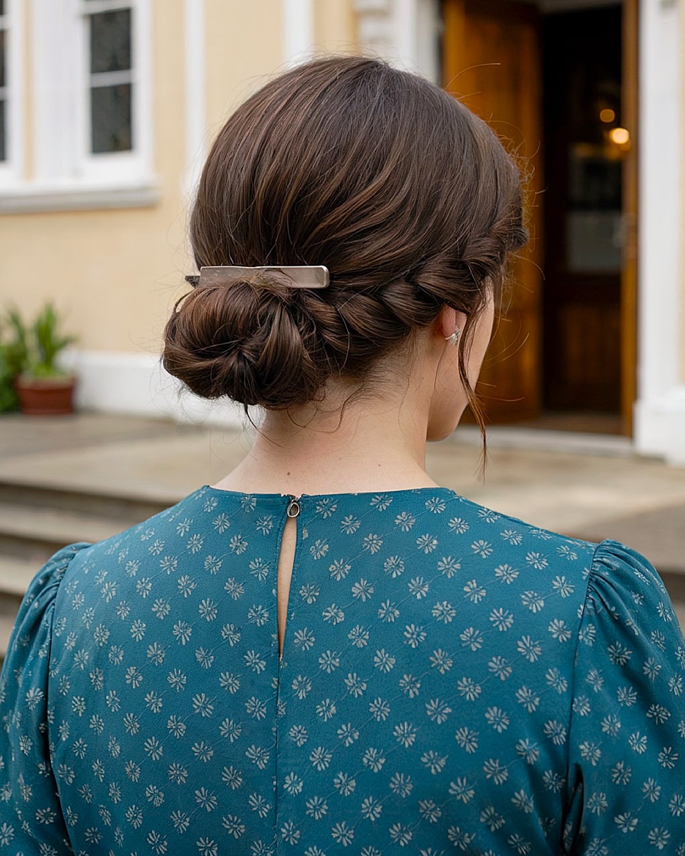 Easy low bun updo with twist and barrette clip on thick brunette hair, perfect for casual events.