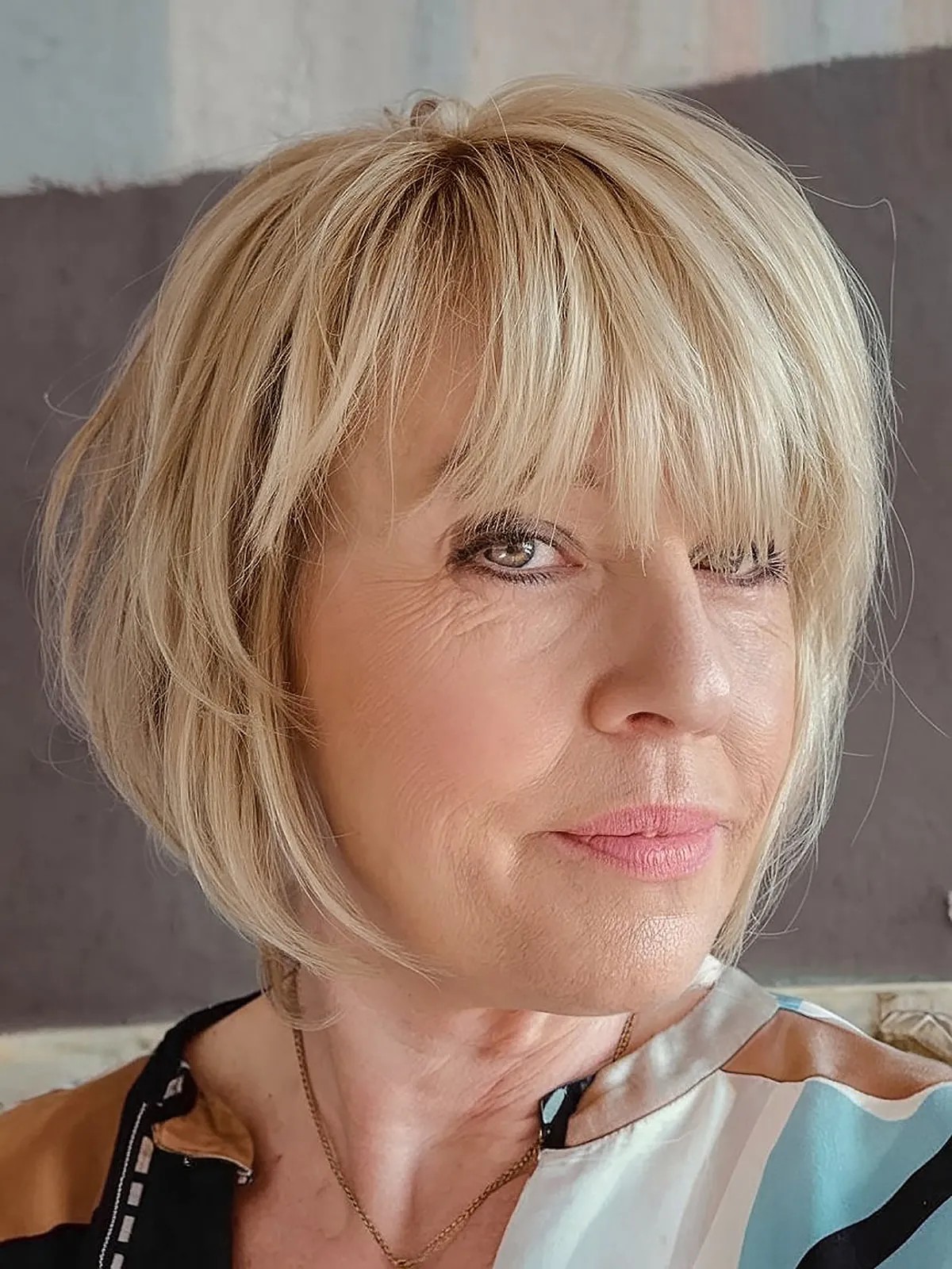 Inverted angled bob with bangs for women over 50
